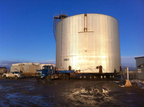 A liquid storage unit being moved my McConnell Building Movers of Millet